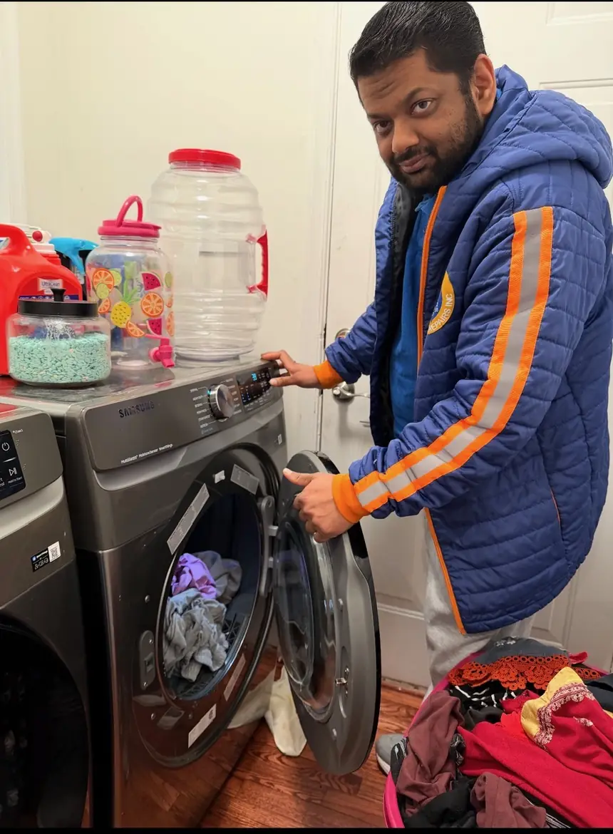 Hi-Tech technician servicing a front-load washing machine in Northern Virginia